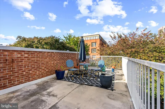 a view of a dining room with furniture a chandelier and wooden floor