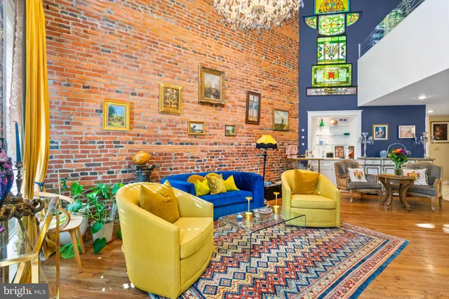 a living room filled with furniture and a book shelf