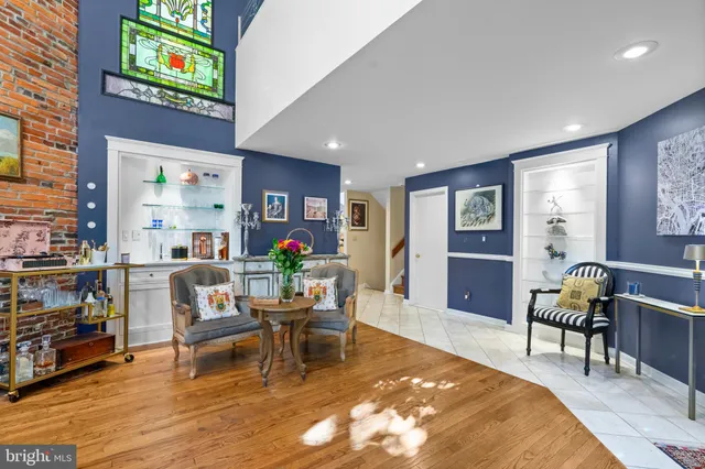 a kitchen with stainless steel appliances granite countertop a stove top oven a sink a dining table and chairs