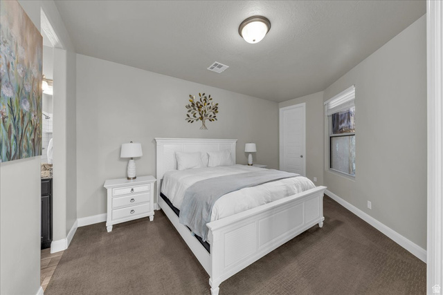 4796 Winged Foot Drive St. George, UT 84770 - Photo 23 of 33 Bedroom with baseboards and dark colored carpet