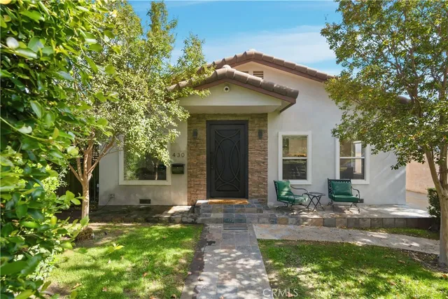 a front view of a house with garden