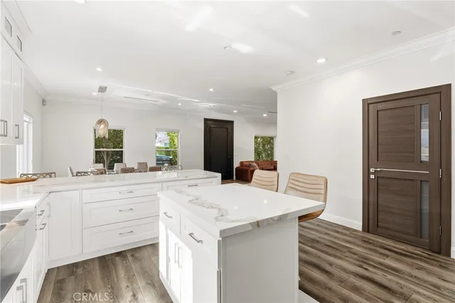 a large kitchen with a table and chairs