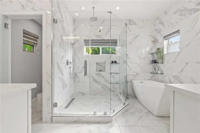 a bathroom with a shower sink and mirror