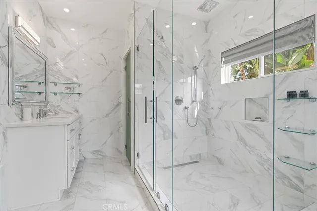 a white toilet sitting next to a white wall