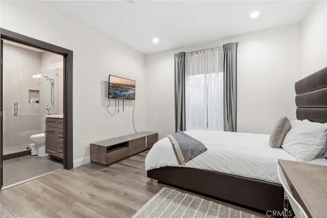 a bedroom with a bed and a mirror