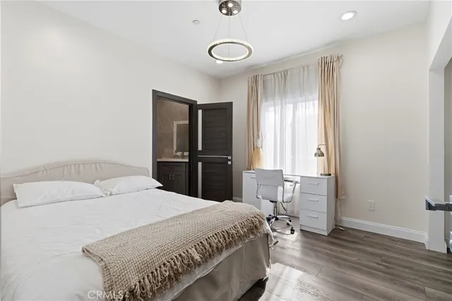 a bedroom with a bed and a lamp