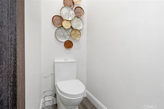 a bedroom with a bed a chair and next to a window