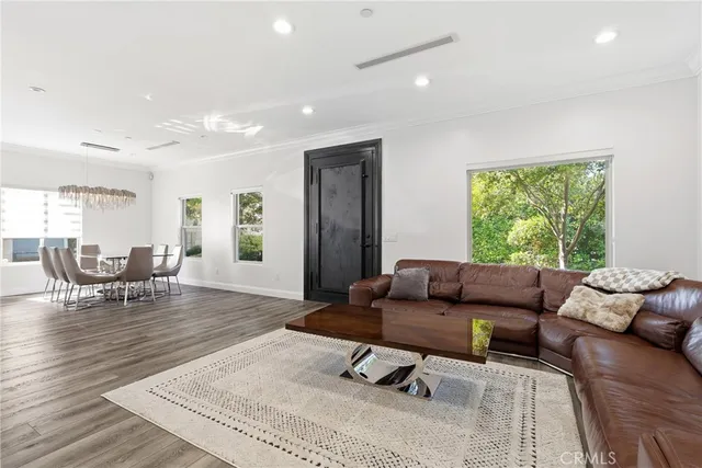 a living room with furniture wooden floor and window