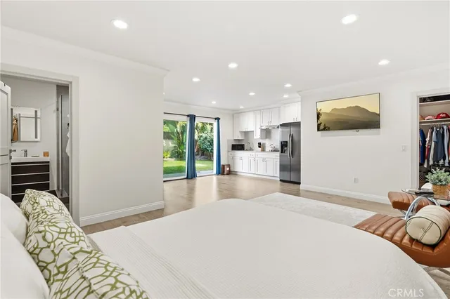an aerial view of a house with a yard and trees all around