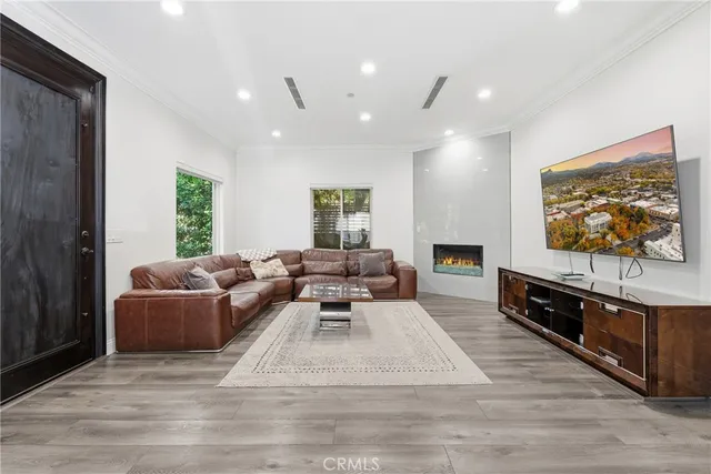 a kitchen with a dining table chairs and white cabinets
