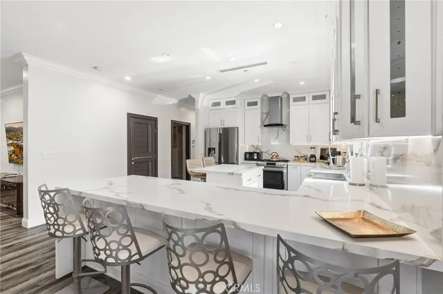 a kitchen with white cabinets and stainless steel appliances