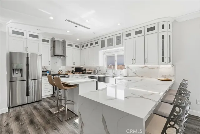 a living room with furniture and kitchen view