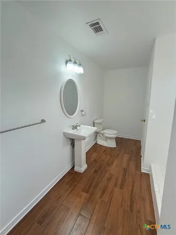 a view of a bathroom with a sink and a mirror