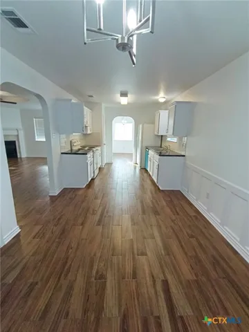 a view of a kitchen counter space with wooden floor