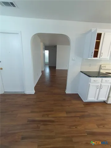 a view of a kitchen from the hallway