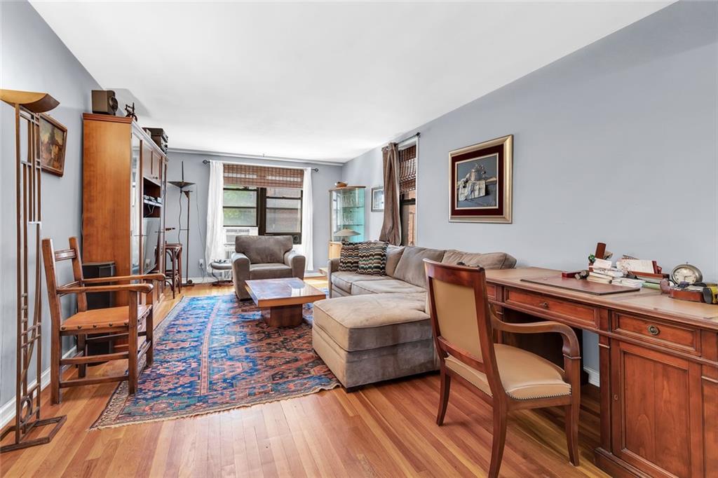 9511 Shore Road, Unit 313 Brooklyn, NY 11209 - Photo 1 of 11 a living room with furniture and a wooden floor
