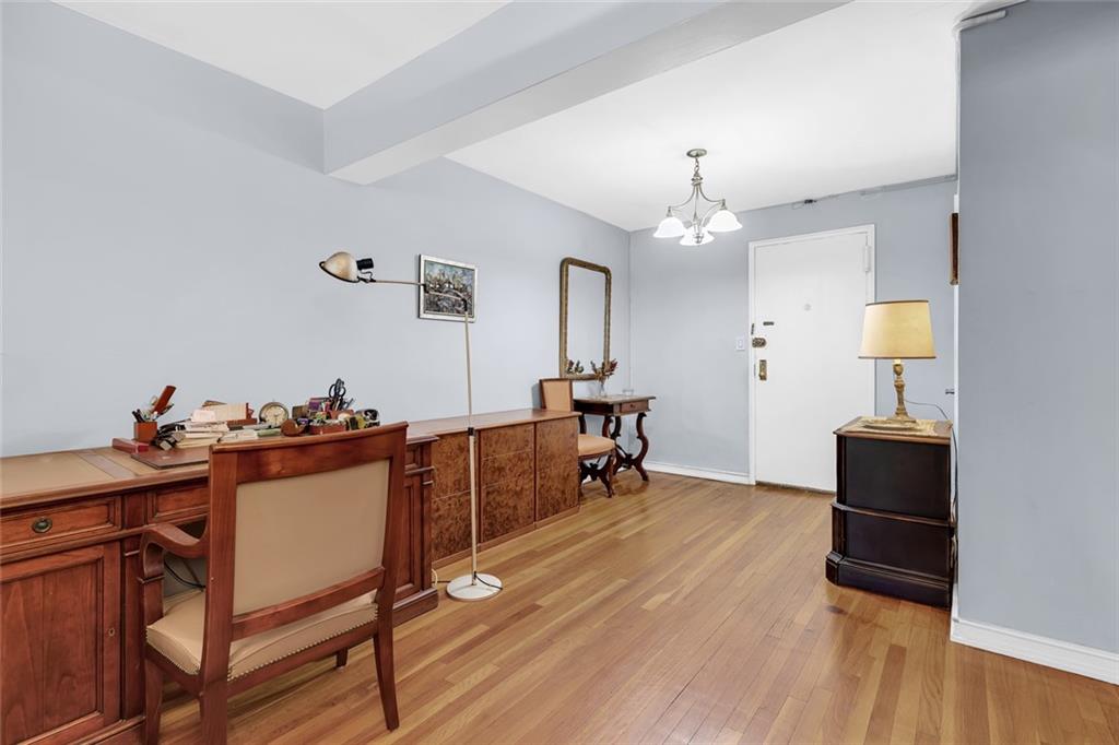 9511 Shore Road, Unit 313 Brooklyn, NY 11209 - Photo 2 of 11 a view of a workspace with furniture and a chandelier