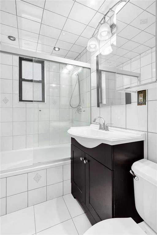 9511 Shore Road, Unit 313 Brooklyn, NY 11209 - Photo 5 of 11 a bathroom with a sink vanity mirror and toilet