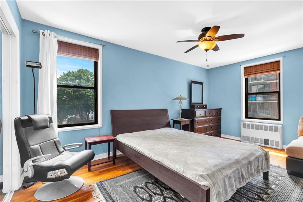9511 Shore Road, Unit 313 Brooklyn, NY 11209 - Photo 6 of 11 a bedroom with a bed and wooden floor