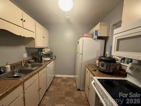 a kitchen with a sink stove and refrigerator