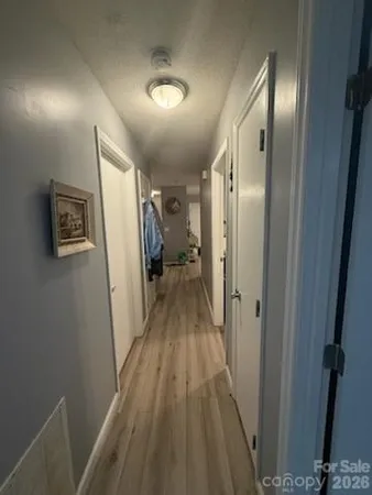 a view of hallway with wooden floor