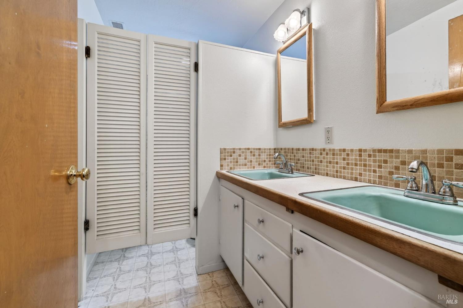 2062 Laguna Road Santa Rosa, CA 95401 - Photo 29 of 80 a bathroom with a granite countertop sink and a mirror