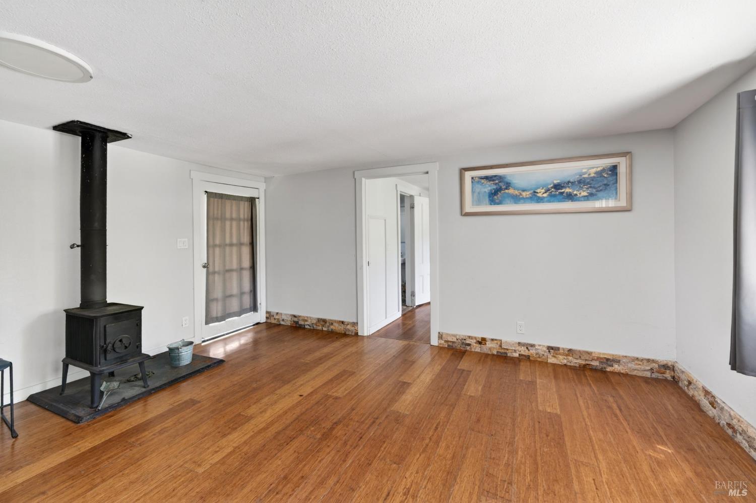 2062 Laguna Road Santa Rosa, CA 95401 - Photo 54 of 80 a view of an empty room with wooden floor and a window