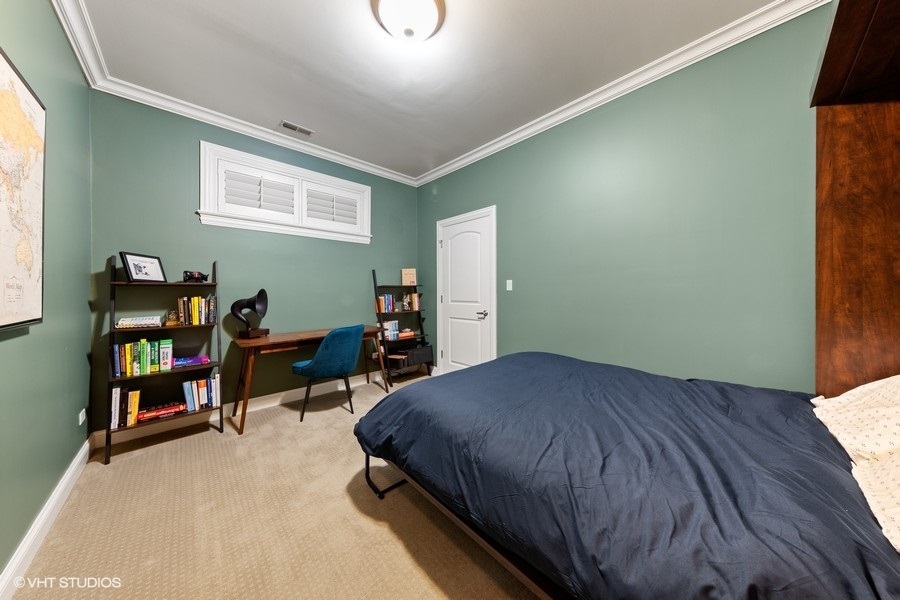 2248 North Racine Avenue, Unit 1 Chicago, IL 60614 - Photo 13 of 27 a bedroom with a bed and a bookshelf