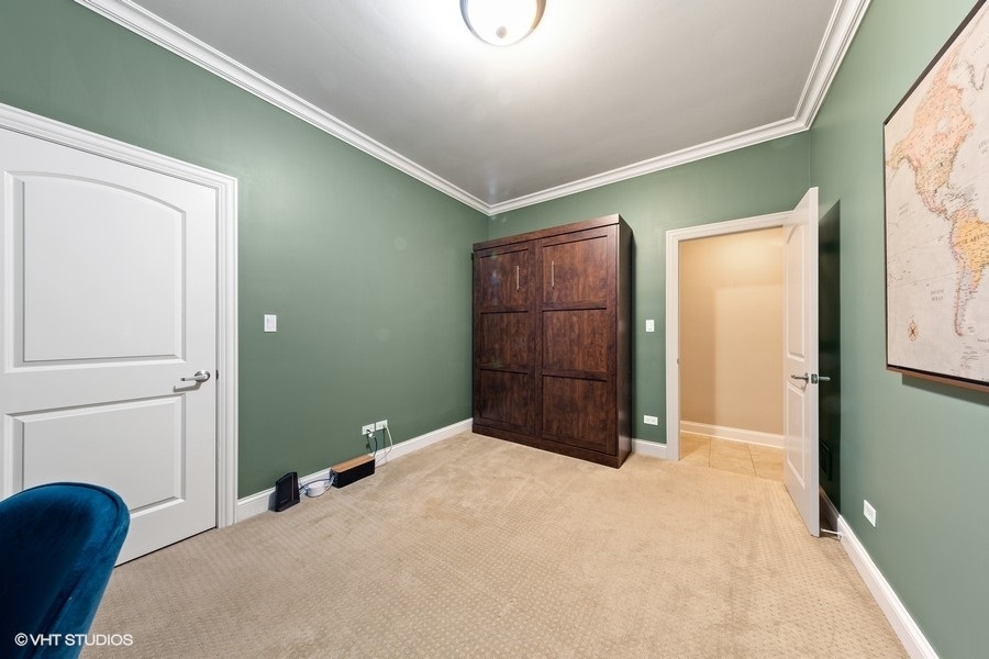 2248 North Racine Avenue, Unit 1 Chicago, IL 60614 - Photo 14 of 27 a bedroom with a bed and a cabinets