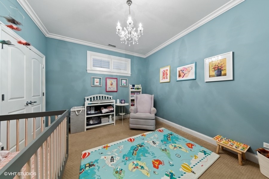 2248 North Racine Avenue, Unit 1 Chicago, IL 60614 - Photo 15 of 27 a bedroom with furniture and a baby crib