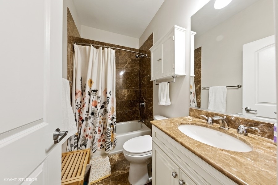 2248 North Racine Avenue, Unit 1 Chicago, IL 60614 - Photo 16 of 27 a bathroom with a granite countertop sink toilet and shower