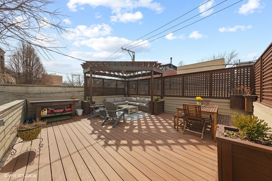 2248 North Racine Avenue, Unit 1 Chicago, IL 60614 - Photo 19 of 27 a view of a roof deck with table and chairs barbeque with wooden floor