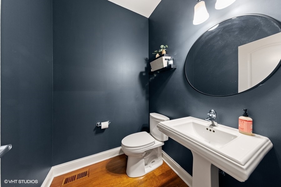 2248 North Racine Avenue, Unit 1 Chicago, IL 60614 - Photo 5 of 27 a bathroom with a toilet sink and mirror