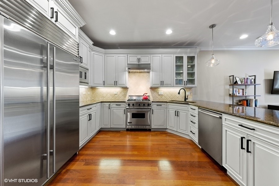 2248 North Racine Avenue, Unit 1 Chicago, IL 60614 - Photo 7 of 27 a kitchen with stainless steel appliances granite countertop a stove and a refrigerator
