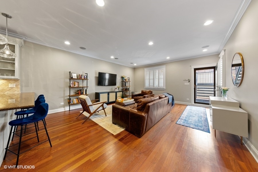 2248 North Racine Avenue, Unit 1 Chicago, IL 60614 - Photo 9 of 27 a living room with furniture and a flat screen tv