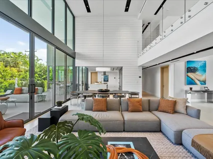 a living room with furniture and large window