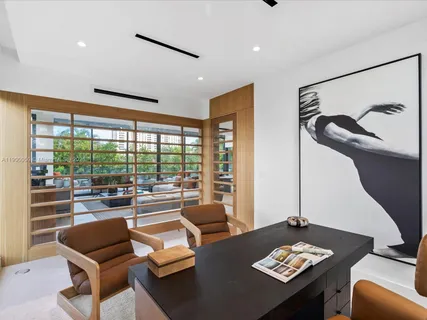 a view of a living room with furniture and a floor to ceiling window