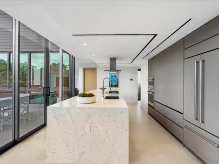 a bedroom with furniture and a large window