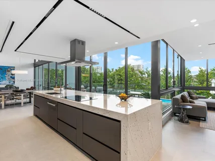 a bedroom with a large bed and a large window