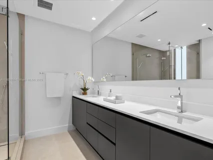 a living room with patio furniture and a potted plant