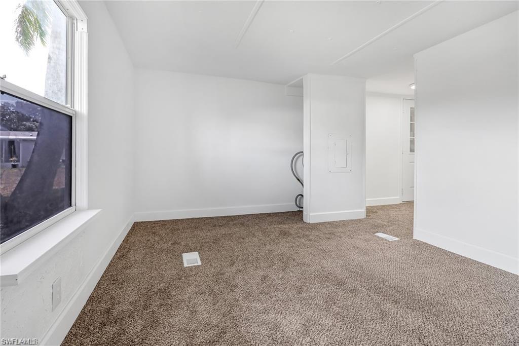 120 Grassy Key Lane, Unit 38 Naples, FL 34114 - Photo 12 of 28 a view of a room with a fireplace