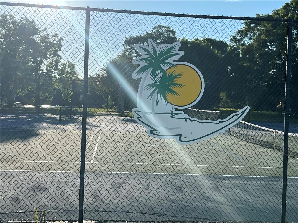 120 Grassy Key Lane, Unit 38 Naples, FL 34114 - Photo 19 of 28 a backyard of a house with swimming pool and wooden fence