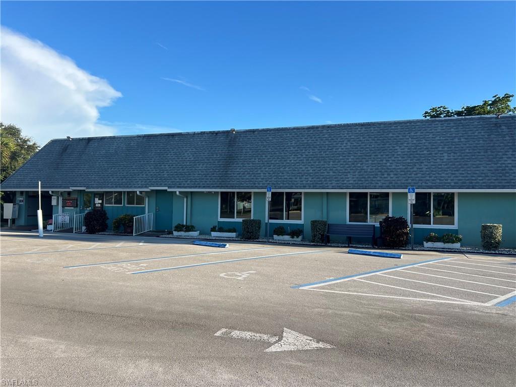 120 Grassy Key Lane, Unit 38 Naples, FL 34114 - Photo 25 of 28 a front view of a building with a garden