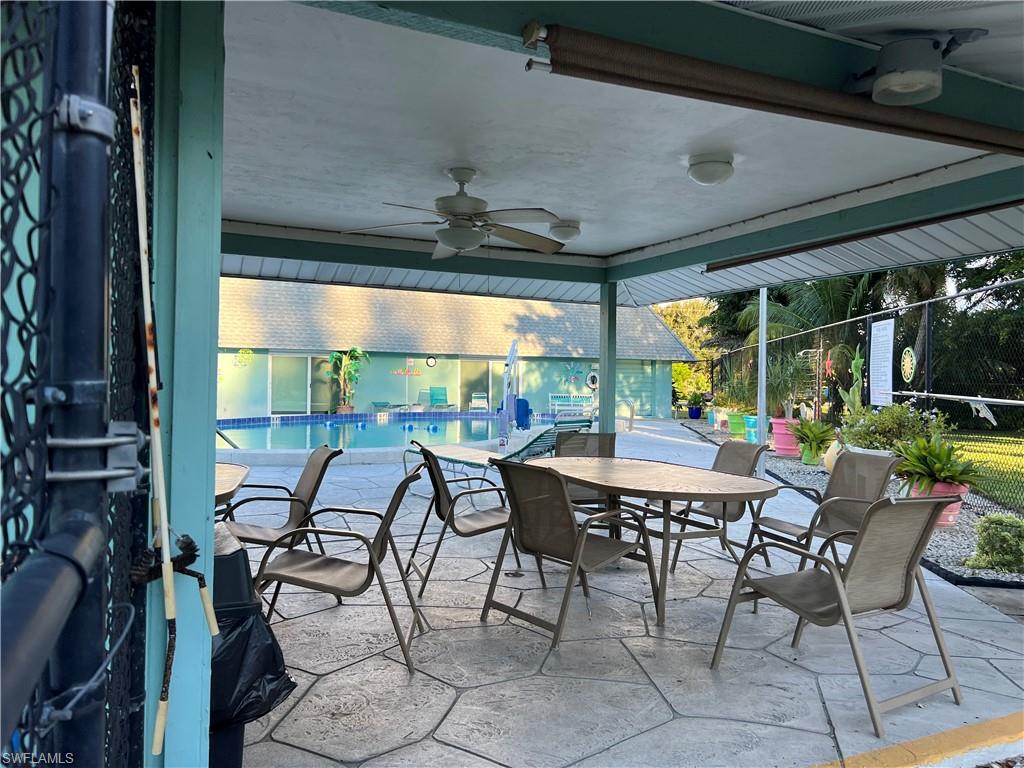 120 Grassy Key Lane, Unit 38 Naples, FL 34114 - Photo 27 of 28 a table and chairs in front of a building