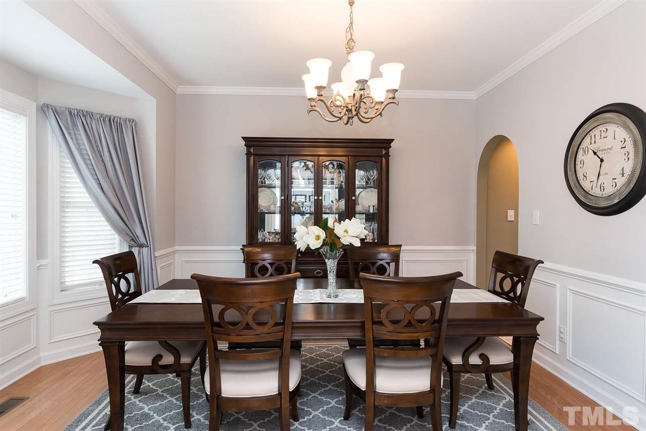 12301 Fieldmist Drive Raleigh, NC 27614 - Photo 3 of 25 Can't you just imagine entertaining friends and family in this gorgeous room? Plenty of space. Bay window too. Hardwoods. Chair rail and wainscoting, crown molding. Plenty of space for a large gathering.