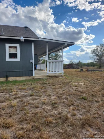a house view with swimming pool in front of it