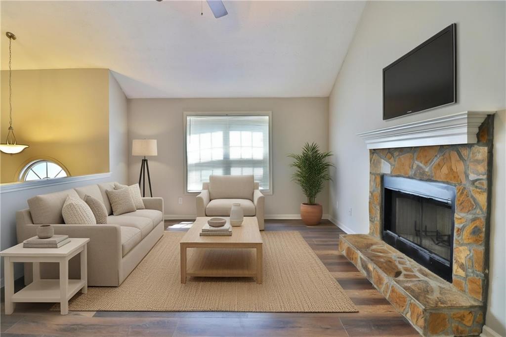 353 Fall View Court Winder, GA 30680 - Photo 22 of 61 a living room with furniture a flat screen tv and a fireplace