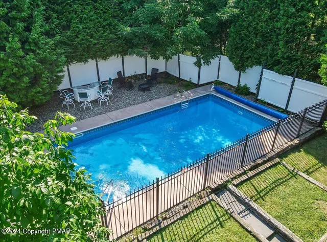 a kitchen with kitchen island granite countertop wooden cabinets a sink and a stove
