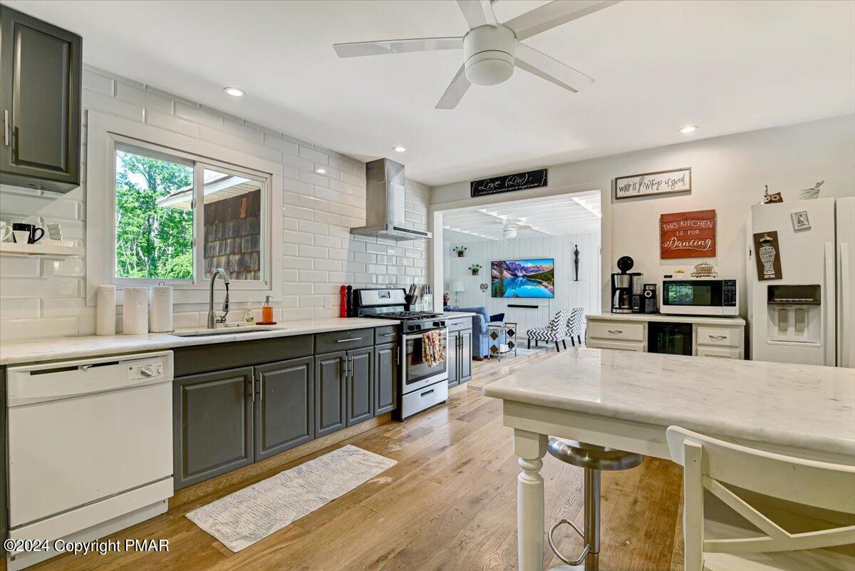 188 Olde Schoolhouse Road Cresco, PA 18326 - Photo 20 of 62 a kitchen with stainless steel appliances granite countertop a sink and wooden cabinets