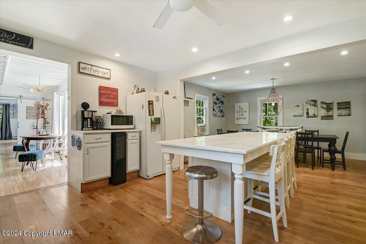 188 Olde Schoolhouse Road Cresco, PA 18326 - Photo 24 of 62 a kitchen with a dining table chairs refrigerator and cabinets